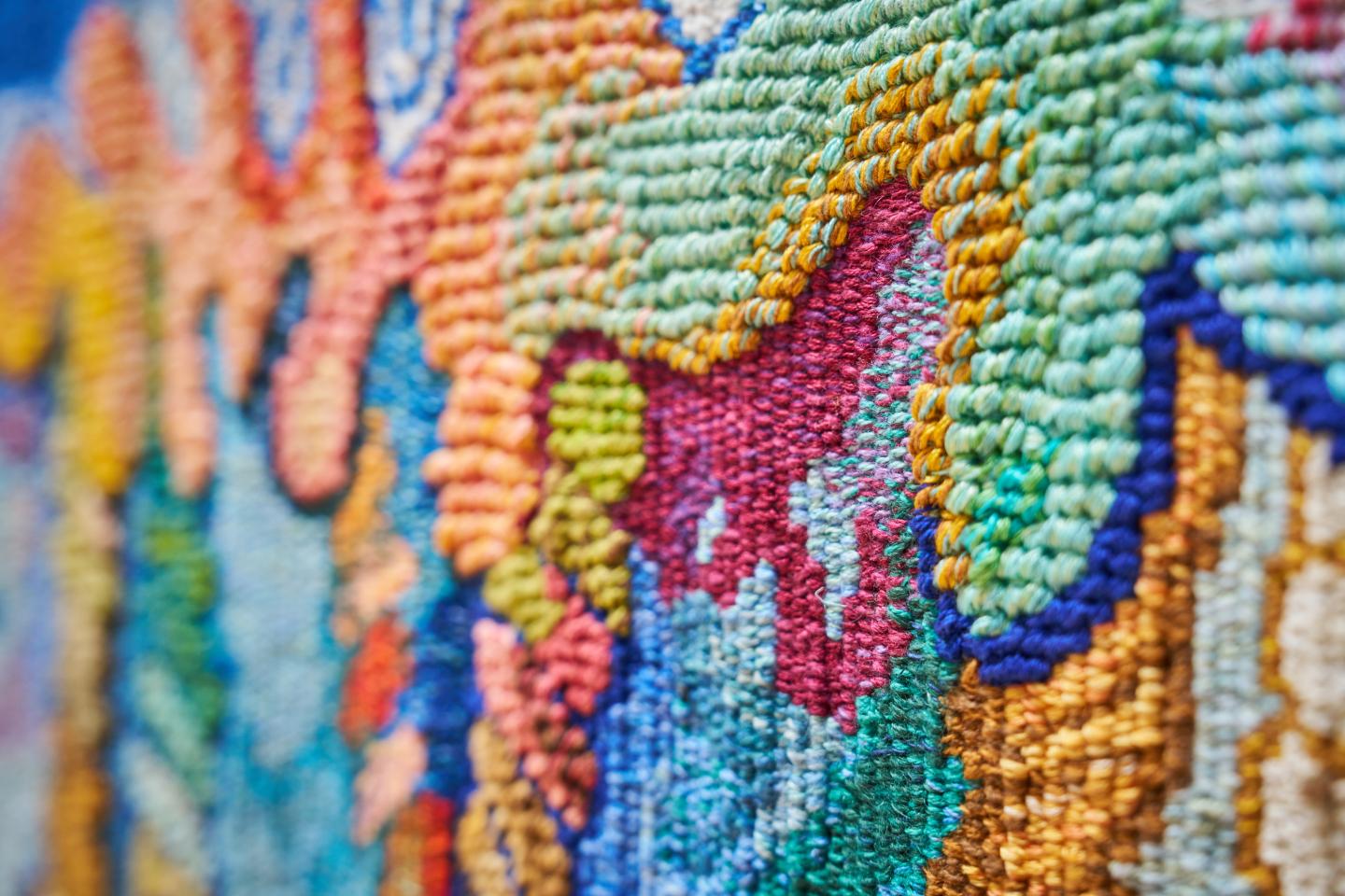 Detail of colourful woven coral borders on a tapestry