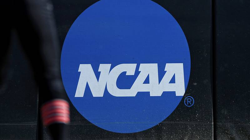 FILE - An athlete stands near the NCAA logo during a softball game in Beaumont, Texas, April...