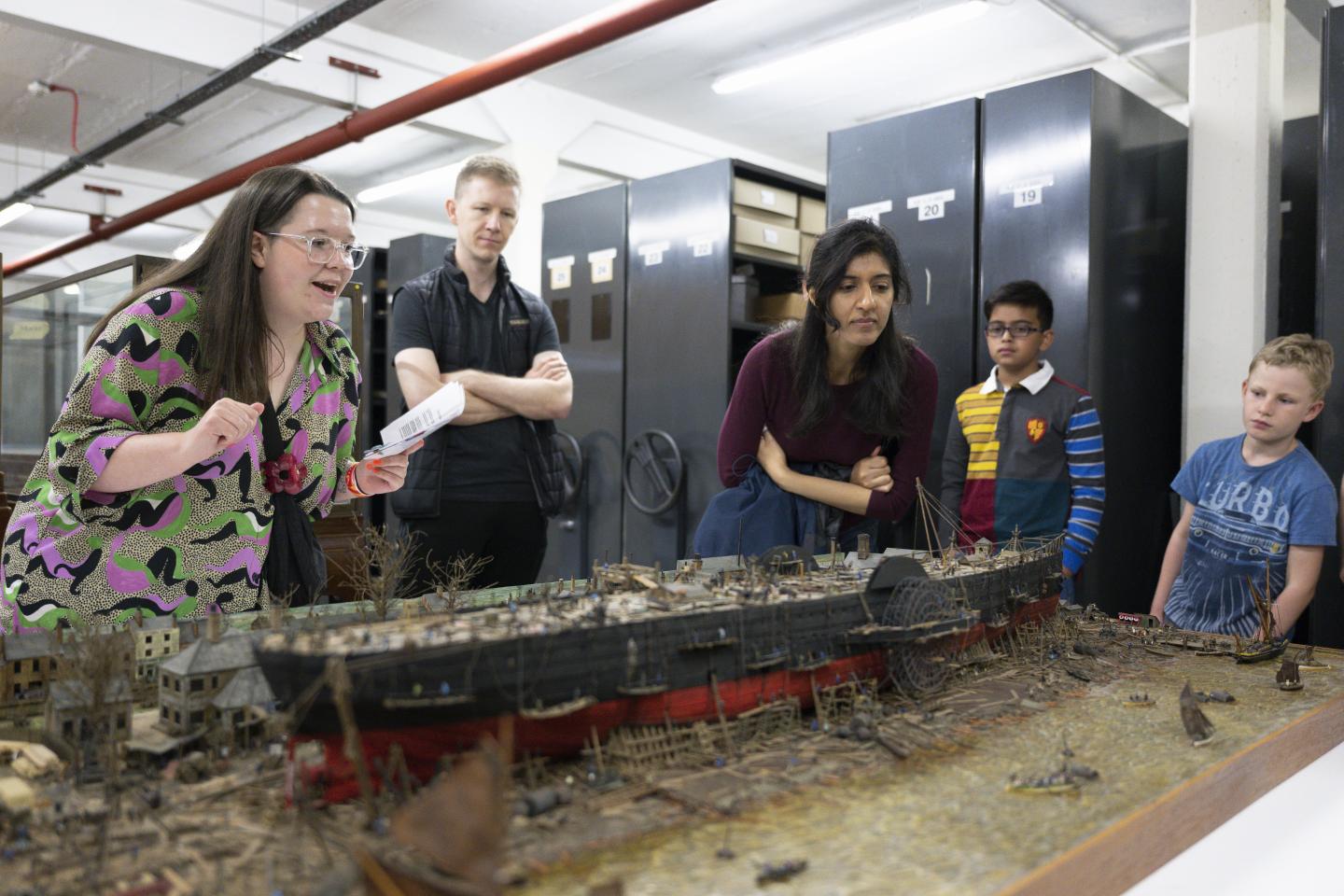 Members of the public looking at an object within the stores.