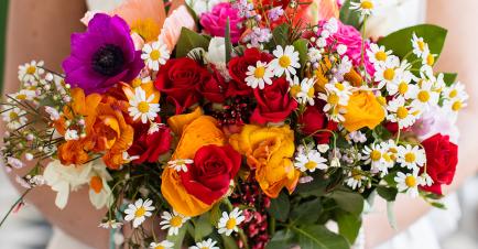 Bride holds a bouquet of flowers from Hybrid