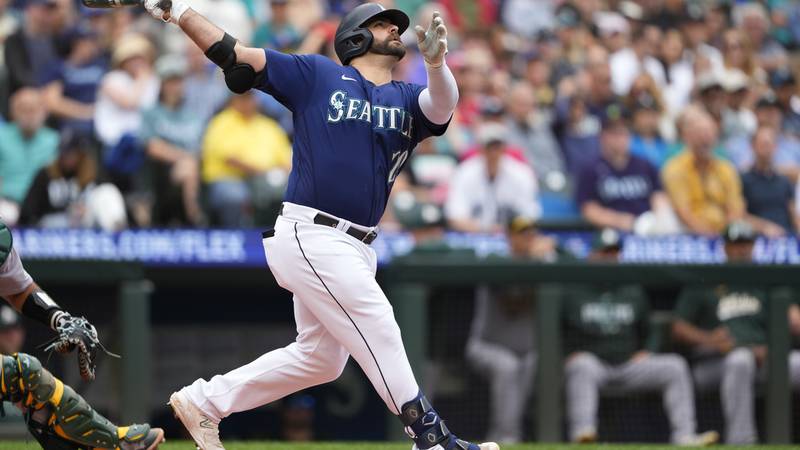 Seattle Mariners designated hitter Mike Ford follows through in a baseball game against the...