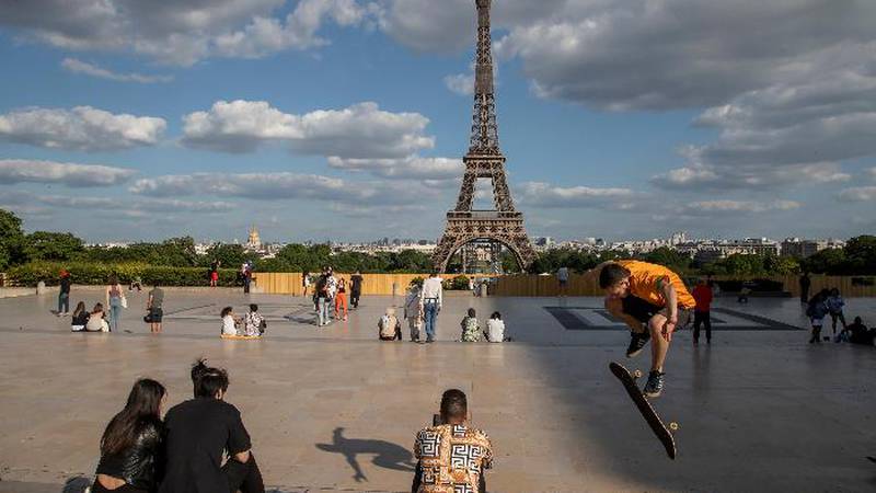 People stroll at Trocadero square near the Eiffel Tower in Paris, Monday, May 25, 2020, as...